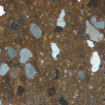 Plate 86.1: Photomicrograph of P&W AM 66 (XPL) (width of field 1.74 mm). Click to see a larger version